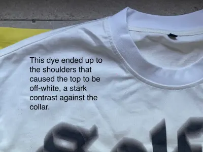 Solflare tee shoulder close-up — dye off-spec